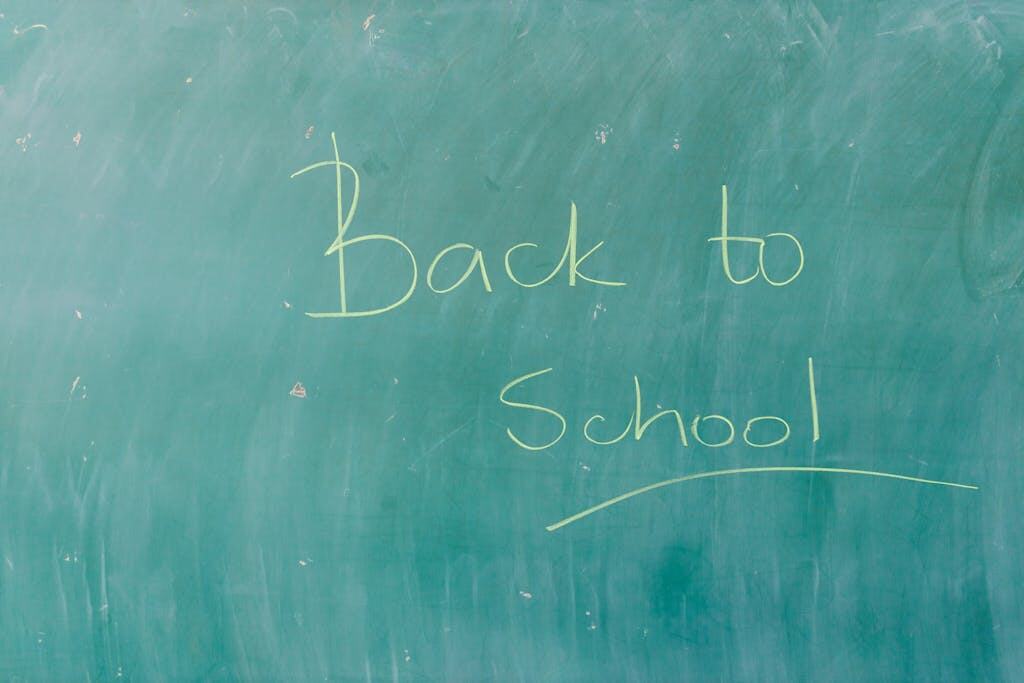 Green chalkboard with 'Back to School' written in chalk, perfect for education themes.